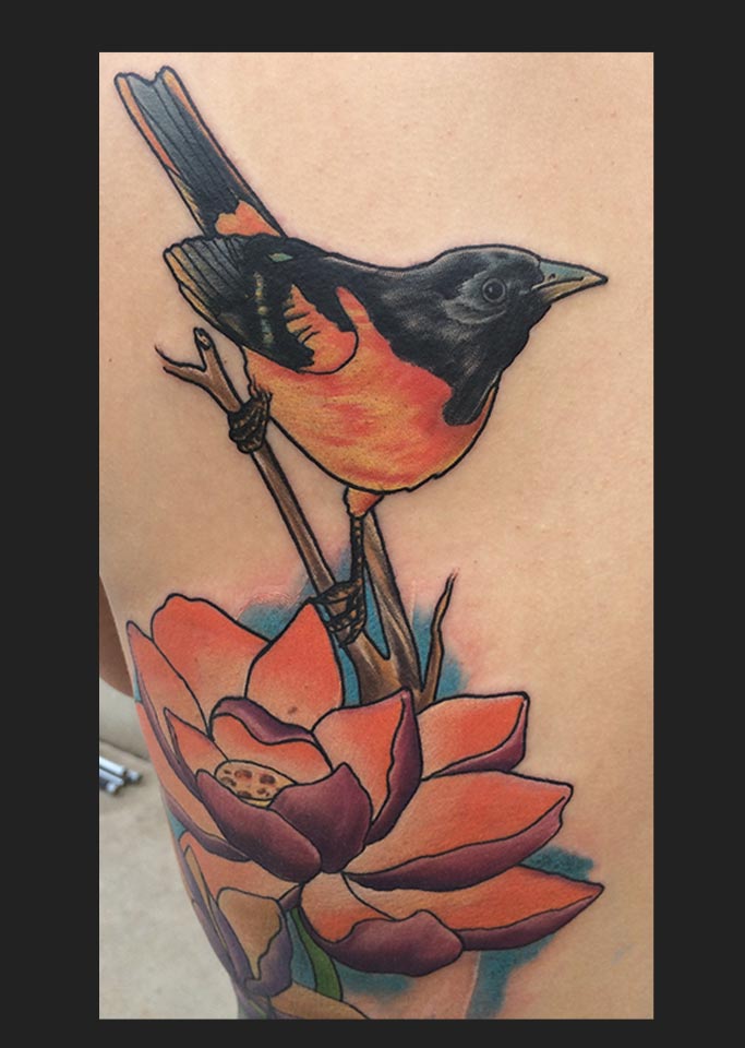 Picture of a bird and lotus flower tattoo